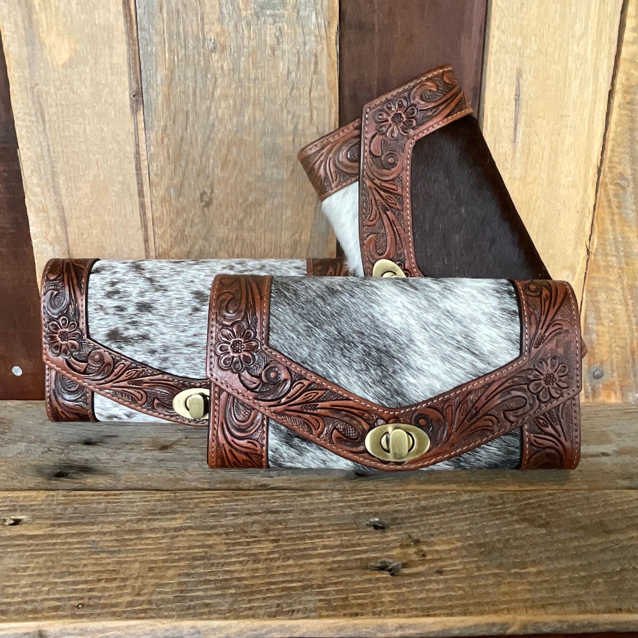 Cowhide tooled western wallet multiple wallets together on display